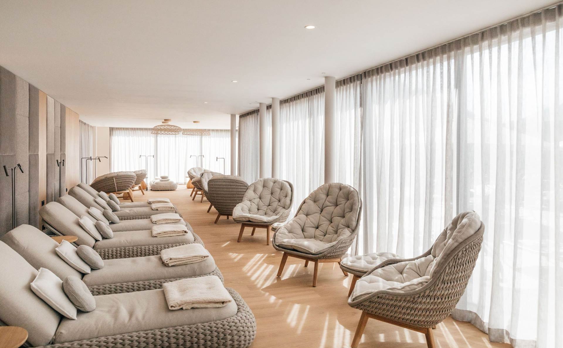 Natürliche Materialien und beruhigende Farbtöne schaffen eine angenehme Atmosphäre Liegen und Stühle im Ruheraum des Hotel Juffing.